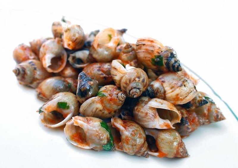 A pile of cooked snails with herbs. 3