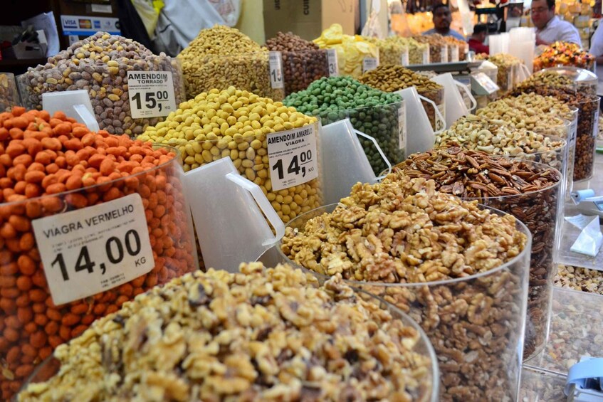 A variety of nuts and legumes for sale at a market. 4