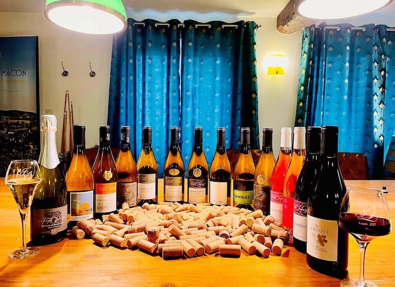 A table with various wine bottles and wine glasses, surrounded by wine corks. 5