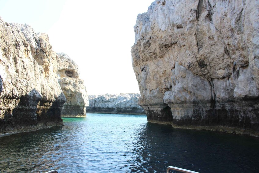 A narrow waterway flanked by rocky cliffs. 5