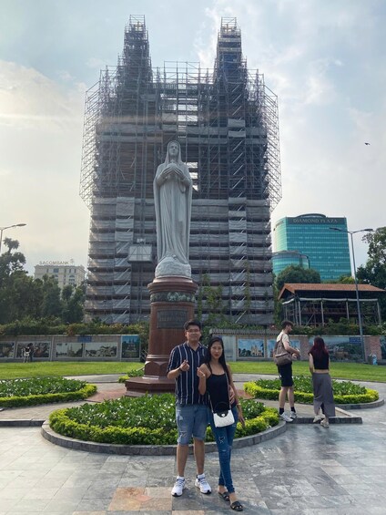 A statue in a public square with a building under construction in the background. 3