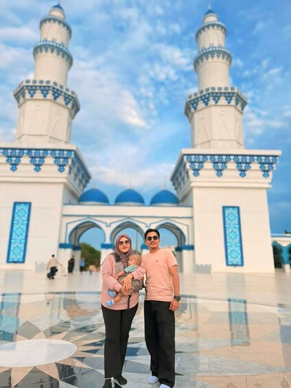 A mosque with two minarets and blue decorative patterns. 3