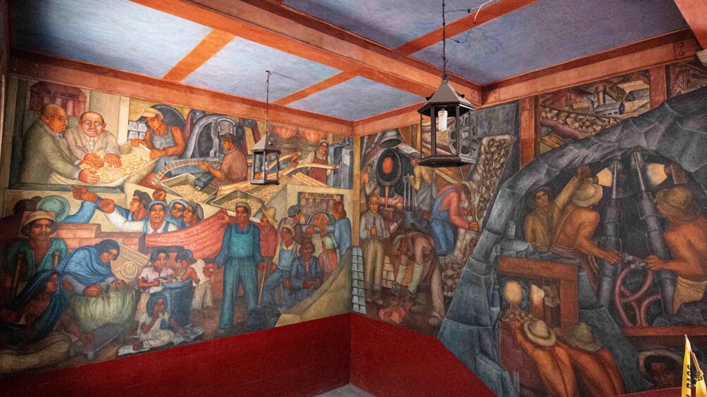 A mural depicting industrial scenes with workers, machinery, and a large clock. 2