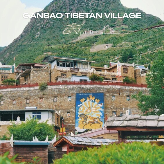 A mountainous village with traditional Tibetan architecture, stone buildings, and a prominent mural. 4