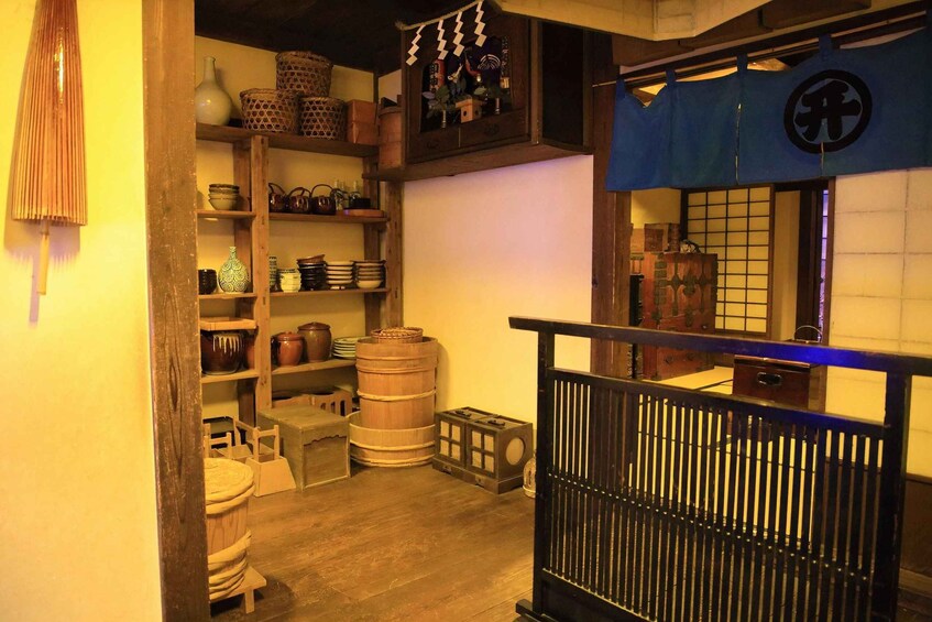 A traditional Japanese interior with wooden shelves, barrels, and a tatami mat floor. 2