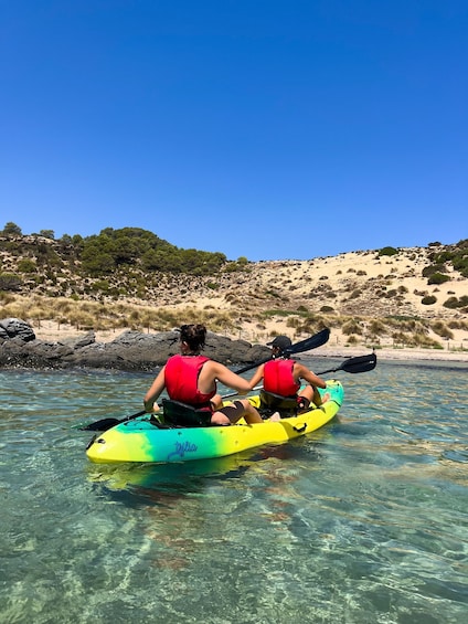 Two people kayaking on a clear day. 4