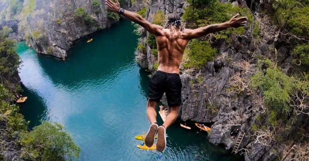 A person jumping off a cliff into a river below. 1