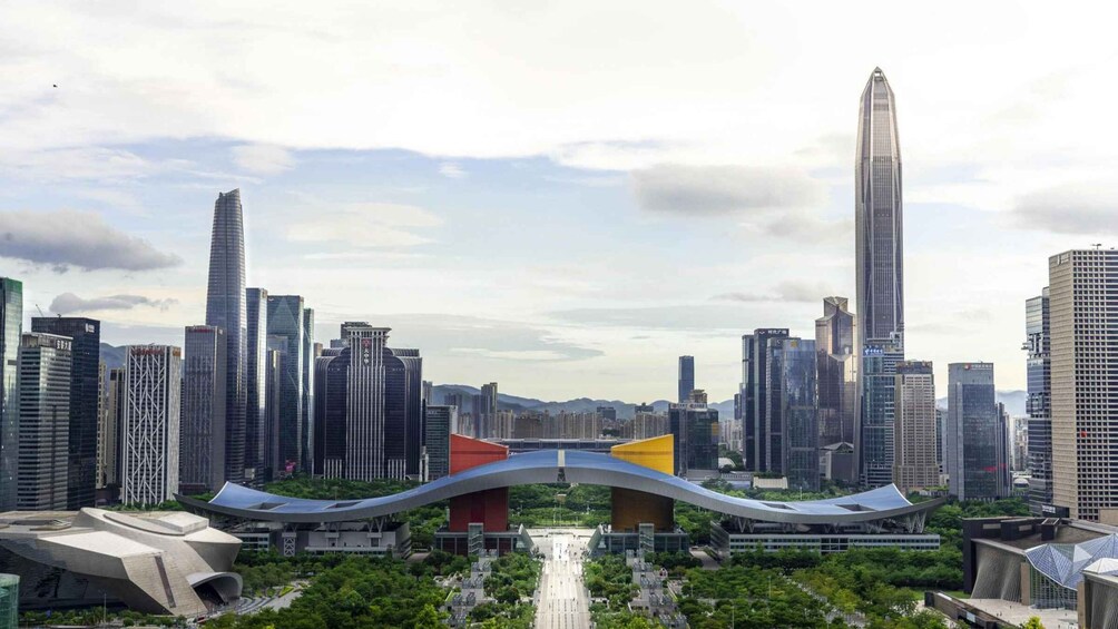 A cityscape with modern skyscrapers, a distinctive bridge, and a river. 3