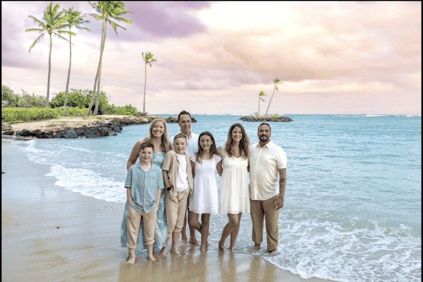 A family on a beach with palm trees and ocean waves. 4