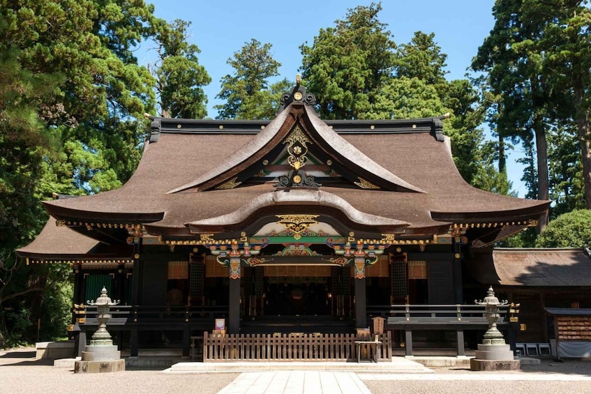 A traditional Japanese temple with a curved roof, ornate decorations, and a central shrine. 3