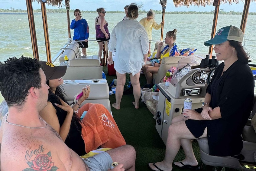 A group of people on a boat with a tropical setting. 2