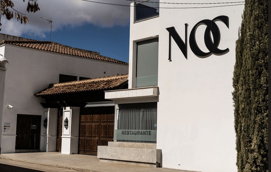A building with a sign reading 'RESTAURANTE' and a large 'NCC' logo. 4