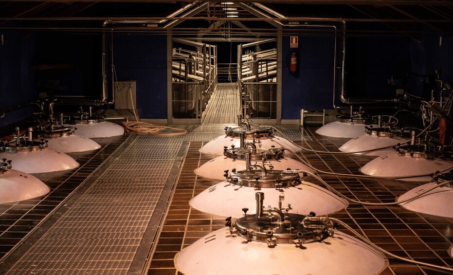 A large industrial facility with multiple large tanks and complex piping systems. 2