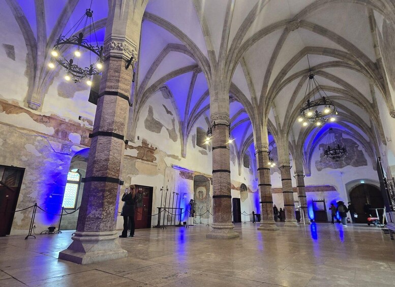 A cathedral interior with high vaulted ceilings, large columns, and chandeliers. 5