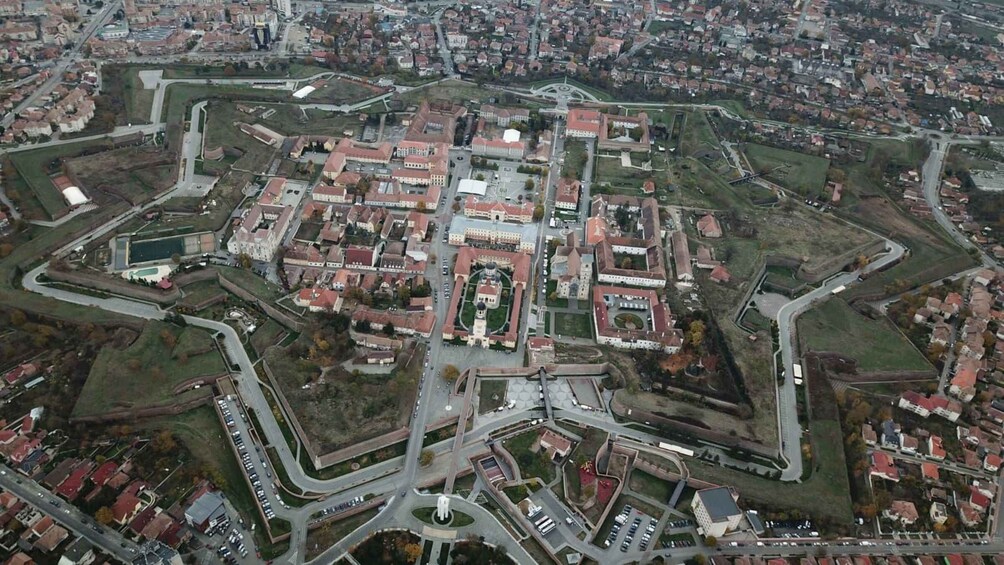 An aerial view of a star-shaped fortress with surrounding residential areas and roads. 1