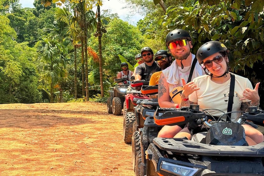 A group of people on ATVs in a forested area. 4
