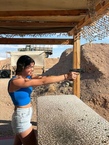 A person aiming a handgun at a target. 3