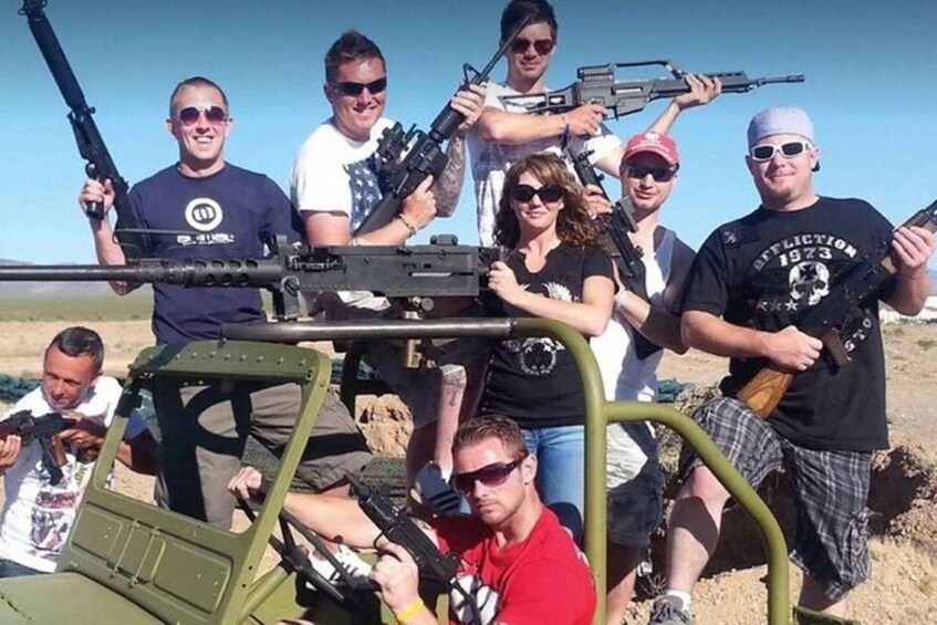 A group of people with rifles in a desert setting. 1