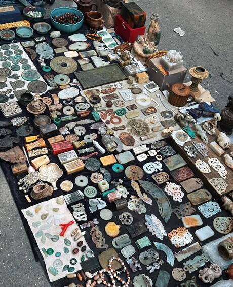 A variety of antique items and collectibles laid out on the ground. 5