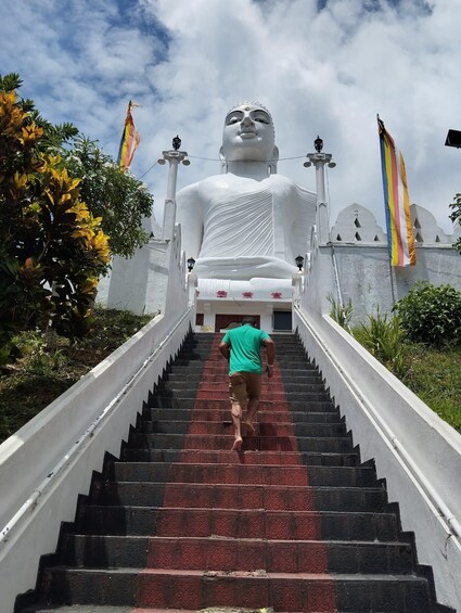 A large white statue at the top of a staircase. 3