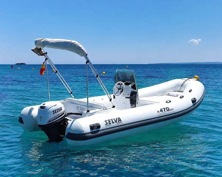 A white inflatable boat named SELVA by TUKY, model D.470 EVO, docked in clear blue waters. 1
