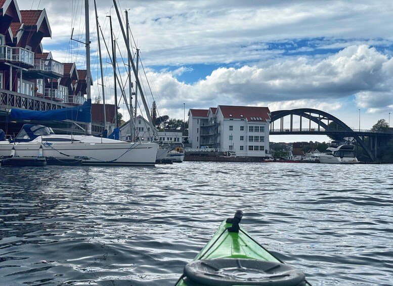 A marina with sailboats, a white building, and a bridge in the background. 3