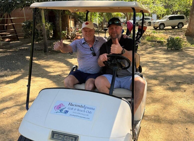 Two people in a golf cart at Hacienda Laguna Golf & Beach Club in Nicaragua. 4