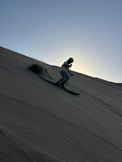 A person skiing down a snow-covered slope. 4