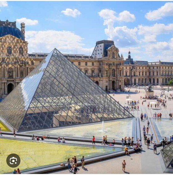 The Louvre Pyramid with visitors in the courtyard. 2