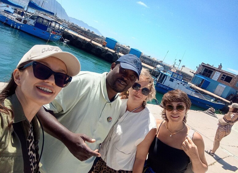 A group of people at a marina with boats docked. 3