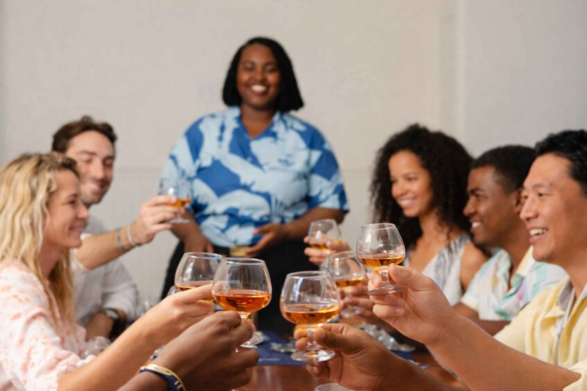A group of people toasting with drinks at a table. 1