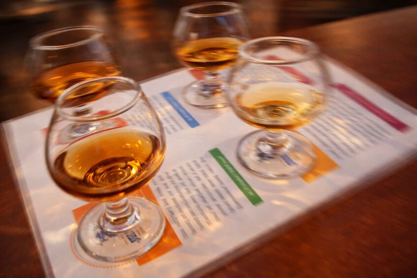 Three wine glasses on a menu with text. 5