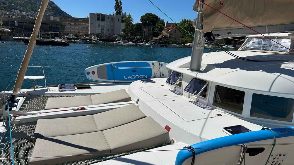 A sailboat docked at a marina with a cityscape in the background. 4
