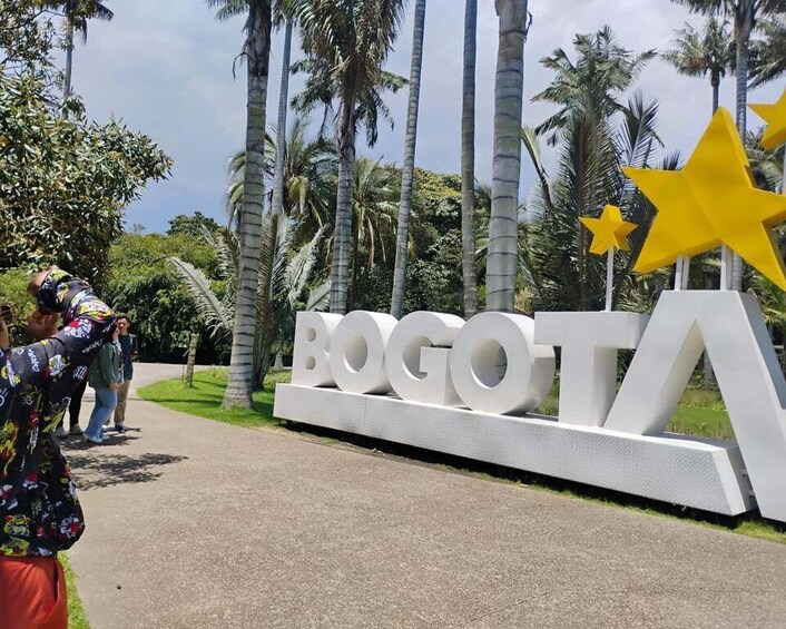 A large white sign with the word 'BOGOTA' and two yellow stars. 4