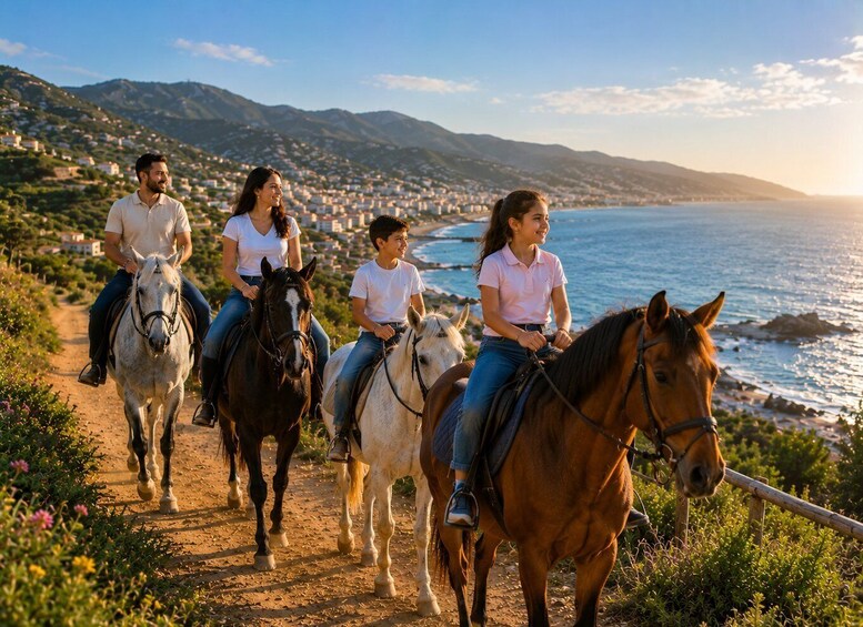 A group of people riding horses along a coastal path with a mountainous backdrop. 3