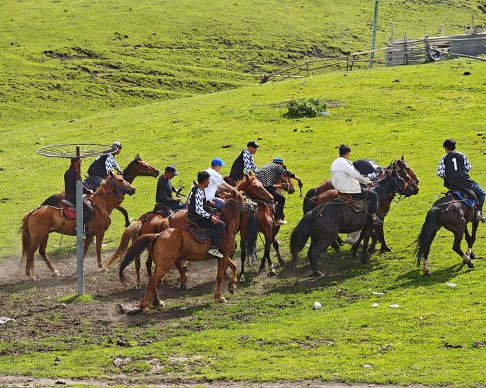 A group of people riding horses on a grassy field. 4