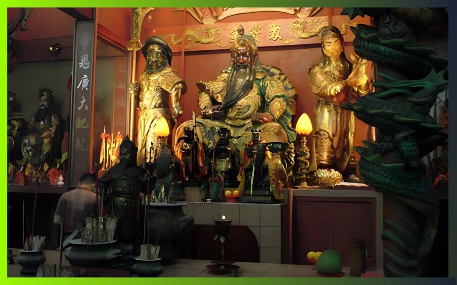 A shrine with golden statues, incense burners, and a dragon sculpture. 2