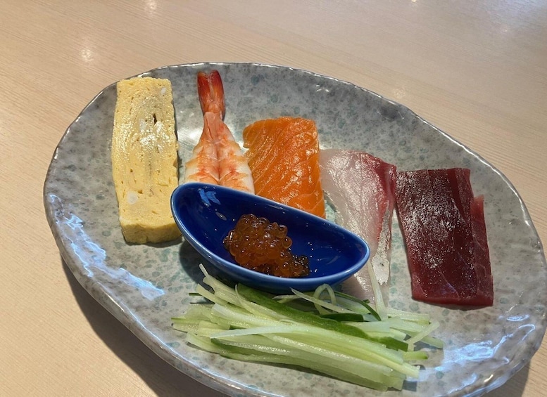 A plate with various sashimi, pickled ginger, and wasabi. 3