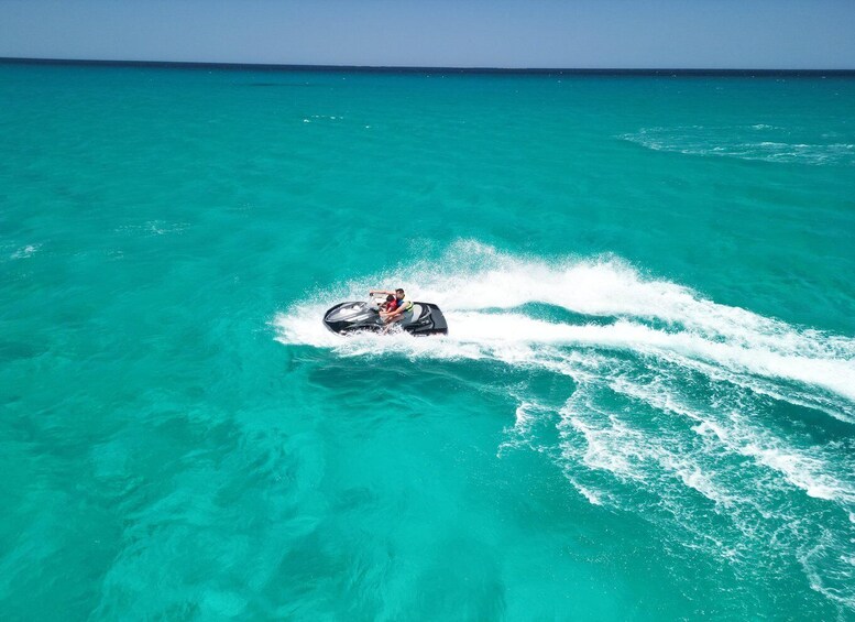 A jet ski moving through turquoise water. 4