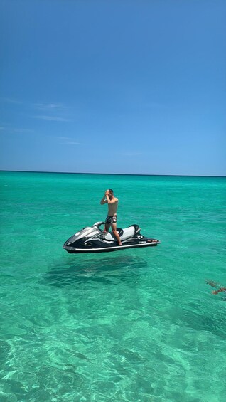 A person on a jet ski in turquoise water. 3