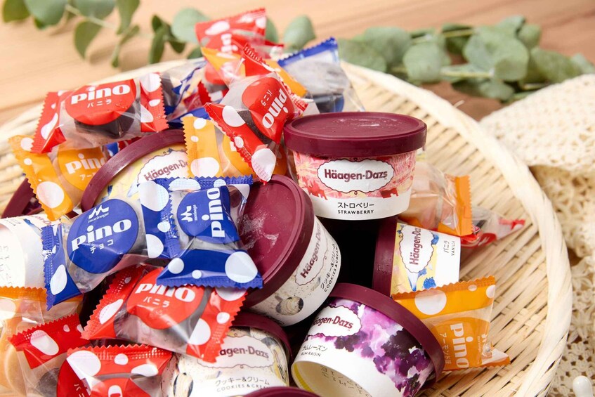 A basket filled with various packaged snacks and a jar of Häagen-Dazs ice cream. 5