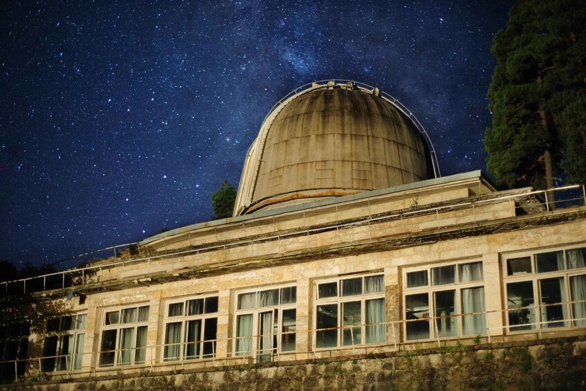 A large observatory dome under a starry night sky. 3