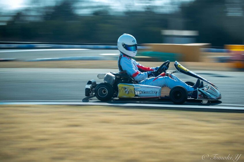 A go-kart racer on a track. 4