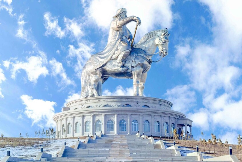 A statue of a figure on horseback on a circular pedestal with steps leading up to it. 1
