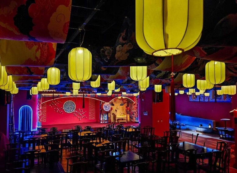 A restaurant interior with traditional decor, yellow hanging lanterns, and red walls. 3