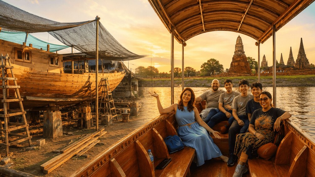 A group of people on a wooden boat near a river with a temple in the background. 1