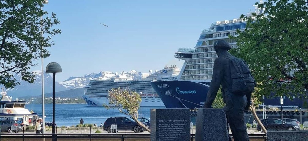 A cruise ship named 'O'neill' docked at a port with a statue of a man in the foreground. 5