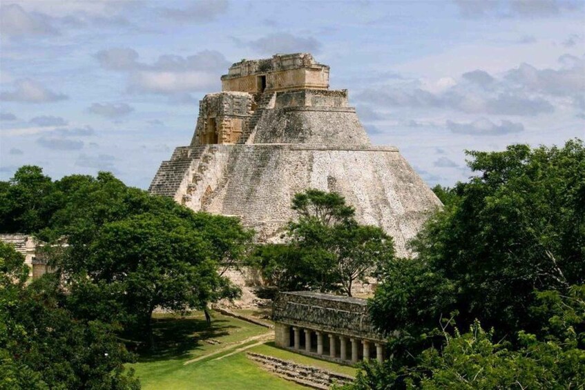 A large pyramid structure surrounded by lush greenery. 2