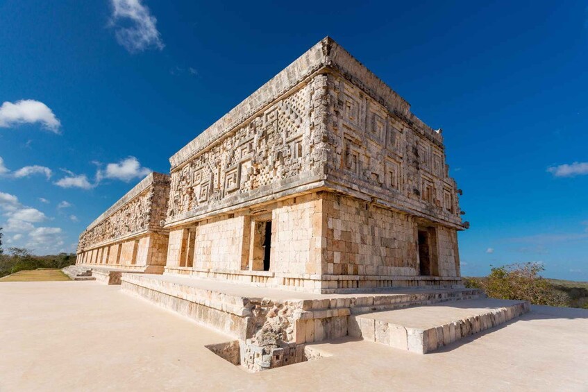 A large, ancient stone structure with intricate carvings, a flat roof, and a stepped base. 4