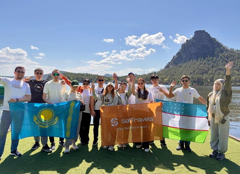 A group of people on a boat with flags and a banner. 2